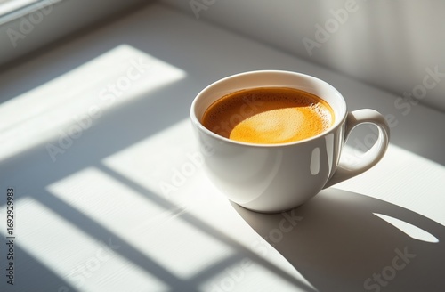 Cozy Coffee Cup Resting on a Sunlit Table With Soft Shadows in a Warm Setting.