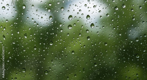 Wallpaper Mural Rain droplets on glass window creating abstract reflective texture with blurred nature background Torontodigital.ca