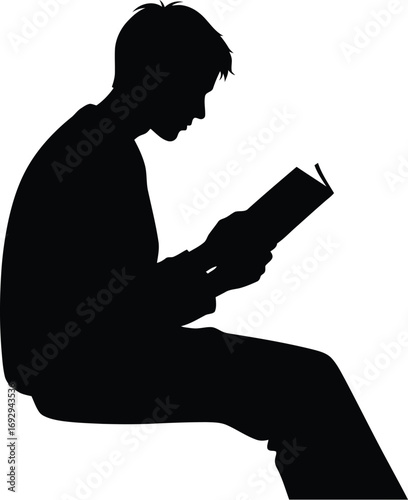 Silhouette of a young man sitting and reading a book image captures a moment of quiet contemplation and intellectual engagement