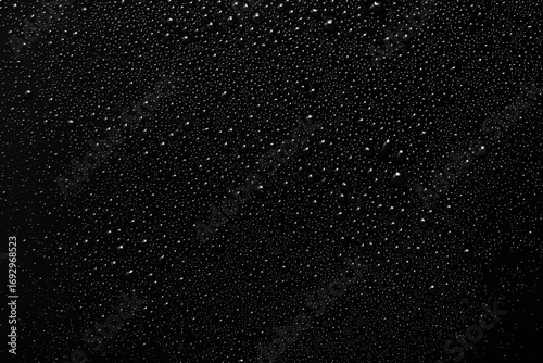 Wallpaper Mural Black and white photo of rain drops on a glass window creating abstract texture and moody atmosphere. Torontodigital.ca