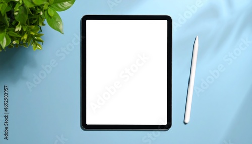 Tablet and stylus on a pastel background with plants