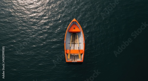 Orange Rowboat Floating on Calm Water - Aerial View