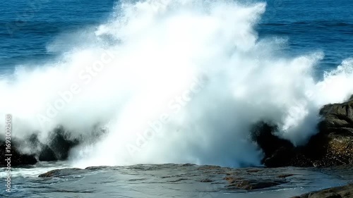Powerful Ocean Wave Crashes on Rugged Coastal Rocks