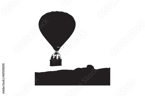 A striking black silhouette of a hot air balloon ascending over a textured landscape at dawn or dusk silhouette