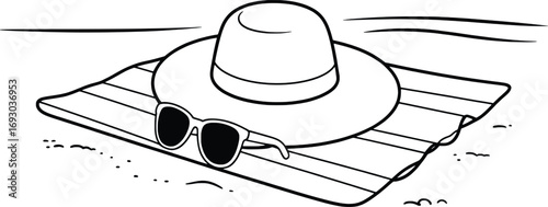 Relaxing beach scene with hat sunglasses and towel on sand ready for vacation