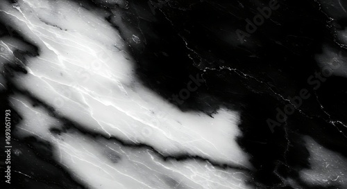 Black and white marble swirls across a polished surface, creating dramatic patterns and textures in a sophisticated and elegant style.