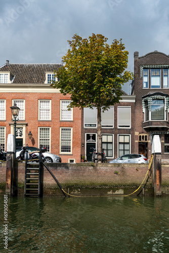 Old historic Dutch homes and buildings stand gracefully along the Wolwevershaven canal in Dordrecht, showcasing timeless architecture, waterfront charm, and the cultural heritage of the Netherlands.