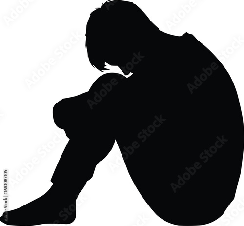 Silhouette of a Sad or Depressed Person Sitting AloneSilhouette of a Sad or Depressed Person Sitting Alone