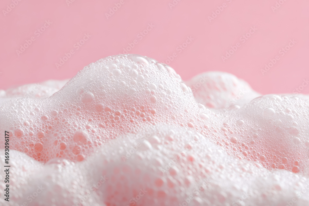 Fototapeta premium Close-up of pink frothy bubbles against a pastel background