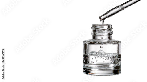 Clear liquid serum dispensed from dropper into a glass bottle