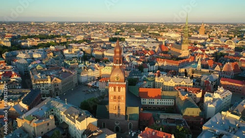 Riga, Latvia, Baltics. Beautiful panoramic aerial 4K video from flying drone to Rigas Dome Lutheran church on a summer, sunset. Old Riga in the background. (Series)