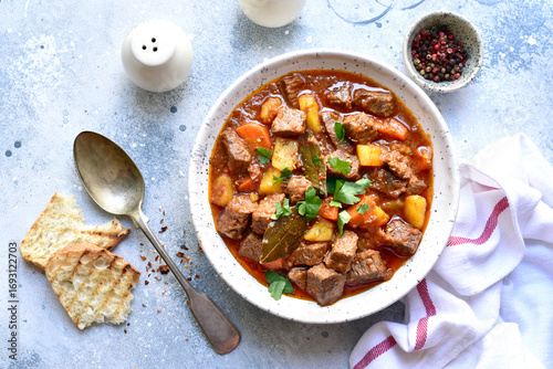 Goulash (meat stew with tomatoes and paprika) - traditional dish of hungarian cuisine .Top view with copy space.