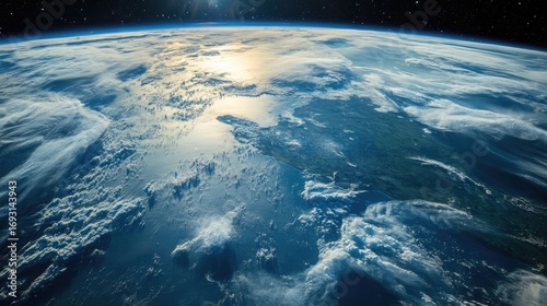 Fototapeta Naklejka Na Ścianę i Meble -  View of Earth from space showing clouds over ocean and landmass. Curved horizon under sunlight with visible atmosphere and space in background. Generative AI