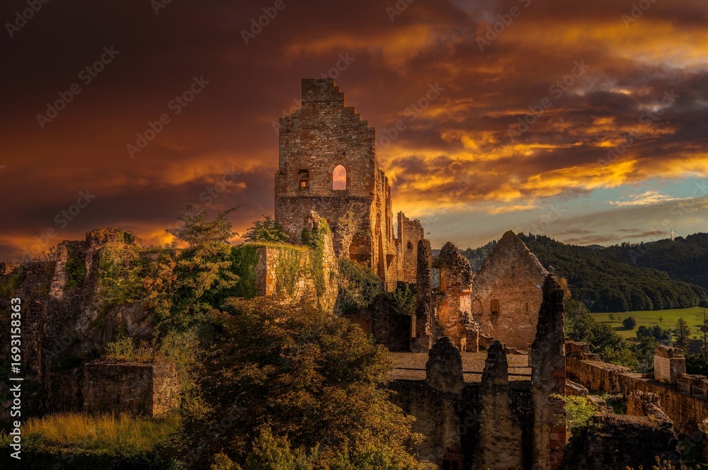 Fototapeta premium Sunset over historic castle ruins.