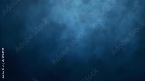 Dramatic abstract dark blue background with mysterious cloudy texture and ethereal light gradient. Deep navy blue wallpaper for atmospheric and moody digital art designs.