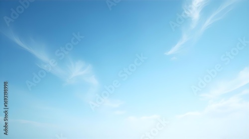 Fototapeta Naklejka Na Ścianę i Meble -  Vast clear blue sky with delicate wispy white clouds, a serene and peaceful natural background image perfect for tranquility, freedom, and open space.