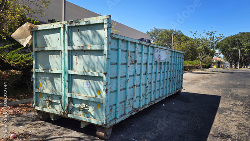 A Large Dumpster Near a Construction Site
