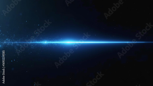 Blue laser beam glows with particles on dark background.  
