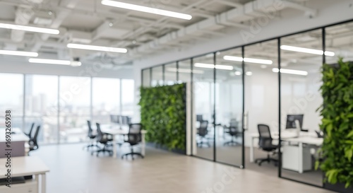 Modern Blurred background of a bright and modern office interior featuring spacious work areas,...