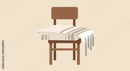 A simple wooden chair with a folded tallit prayer shawl draped over it.
