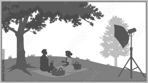 Silhouette of a Couple on a Picnic Blanket Under a Tree with Studio Lighting Setup.