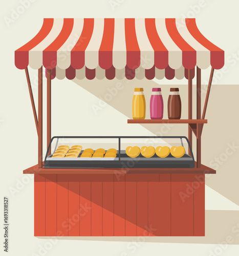 A vibrant market stall featuring an array of delicious pastries, attractively displayed along with colorful condiments in bottles, creating an inviting atmosphere.