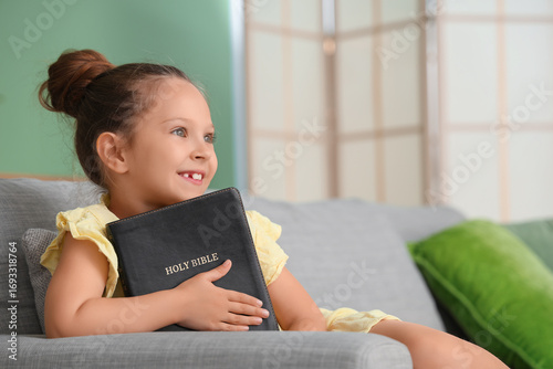 Cute little girl with Bible...