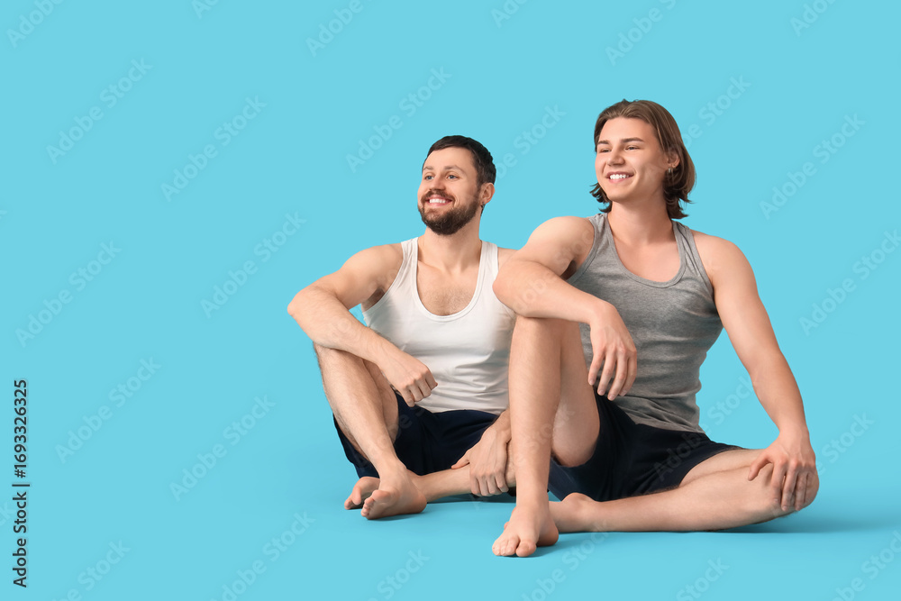 Obraz premium Men sitting on blue background. Body positive concept