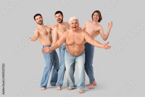 Group of happy men on grey ...