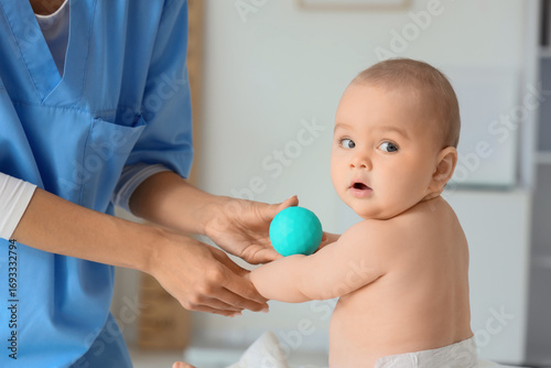 Female therapist massaging ...