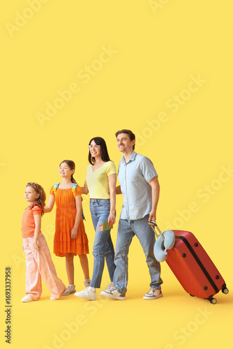 Family of tourists with sui...