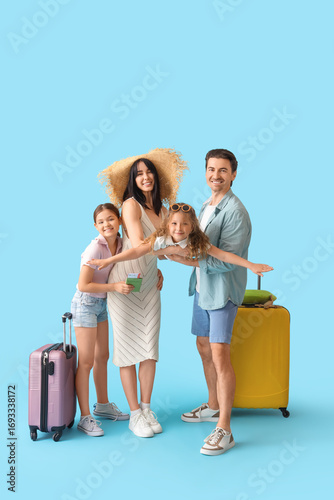 Family of tourists with sui...