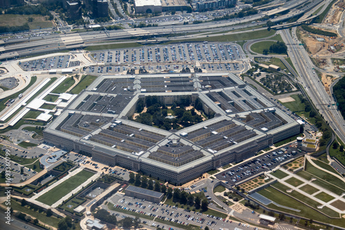 Aerial view of the Pentagon complex with surrounding roads, parking and greenery. g.