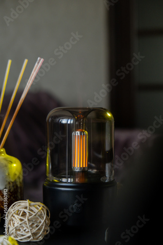 Close up of home perfume scent air humidifier with light. Aromatherapy holistic health practices concept. Stress relief activities preparing for meditation. Simple pleasures healing habits
