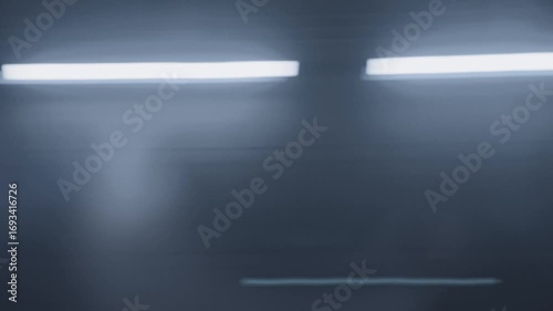 Side view of train passing by at high speed. The subway is moving forward, and the motion blur effect is.