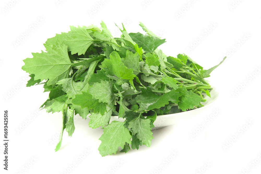 Fototapeta premium Fresh Green Leafy Vegetables in White Bowl - Healthy Organic Produce on White Background