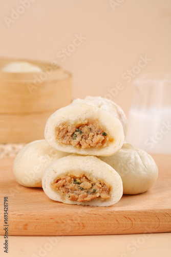 Freshly Steamed Chinese Xiaolongbao Soup Dumplings with Pork Filling on Bamboo Board