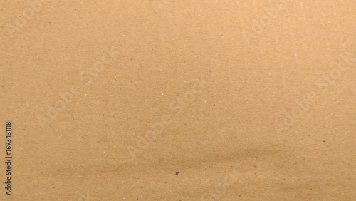 Background of brown kraft paper or cardboard texture. Abstract pattern of beige rough carton, old paper sheet, parchment or papyrus surface.