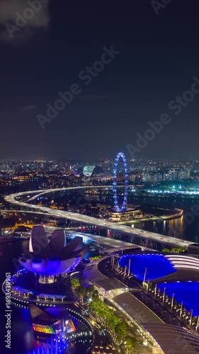 night illumination singapore city marina bay famous hotel mall aerial vertical panorama 4k timelapse
