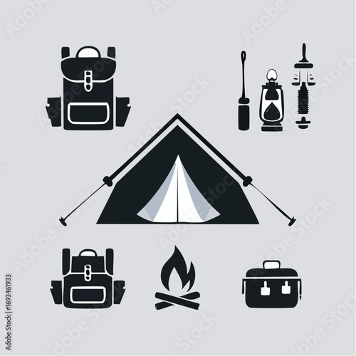 Camping equipment arranged neatly on a light gray surface, evoking a sense of adventure and preparedness for outdoor exploration.