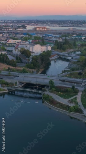 Wallpaper Mural Aerial view of Oakland, California, USA, at dusk. The photo shows Lake Merritt, buildings, bridges, and a park. The image captures the city's beauty and urban landscape. Torontodigital.ca