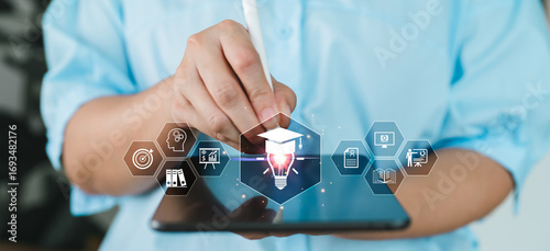 Hand using stylus on tablet with education icons, online learning, e-learning, digital education system, virtual classroom and smart training for academic development. Certification course training.