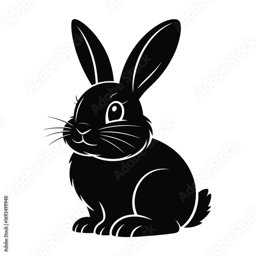 Cute black bunny rabbit sitting and looking forward
