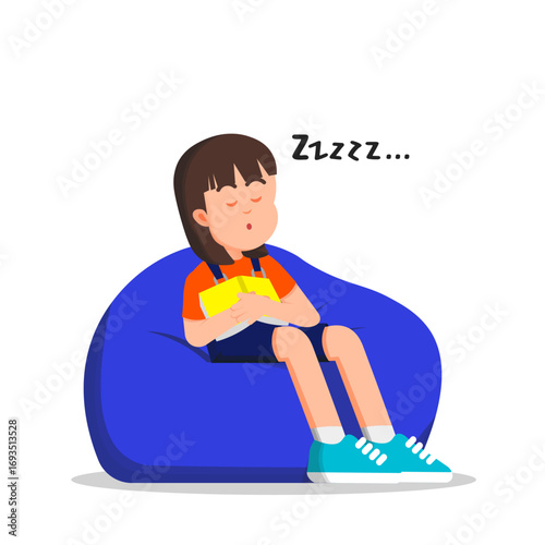 A little girl sleeps peacefully on a beanbag, hugging a book close to her chest