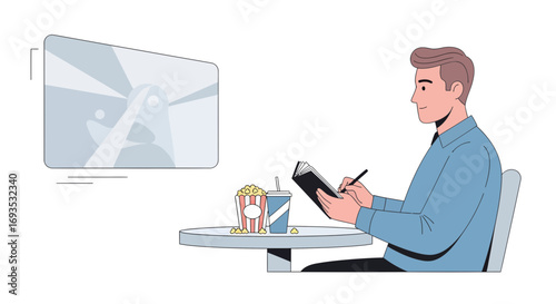 Man at a cafe with a notebook, popcorn, and a drink looking at a screen
