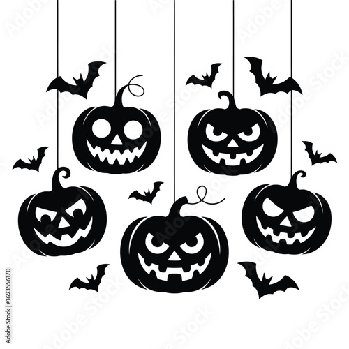 Spooky halloween pumpkins and bats hanging on strings