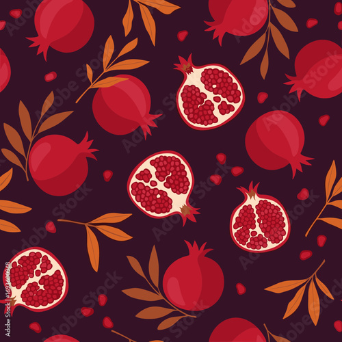 Seamless pattern of ripe pomegranates and autumn leaves on a dark background