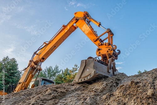 Excavator boom, arm (dipper,stick), and bucket against blue sky