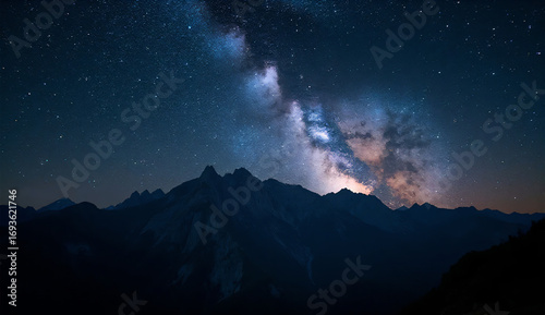 Starry night sky with Milky Way above mountains