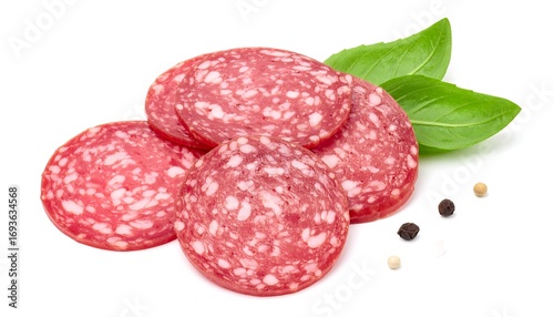 Sliced salami with basil leaves and pepper